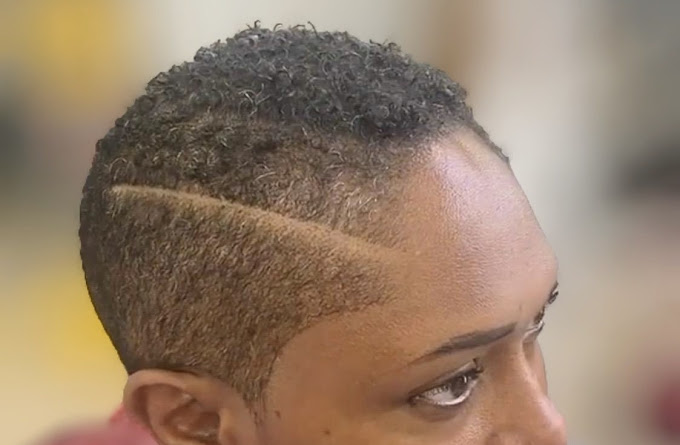 A close up of a person with a shaved head